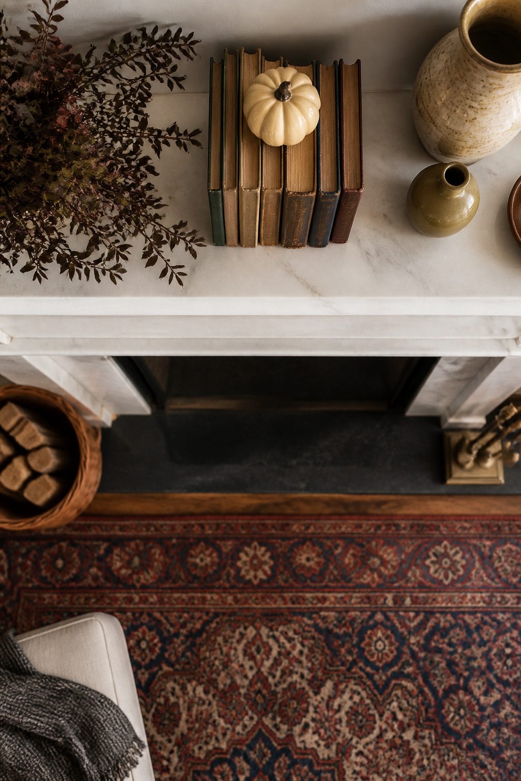 11 Fall Mantel Decoration Ideas for a Styled Hearth 9 Books stacked horizontally on a mantel with decorative items.