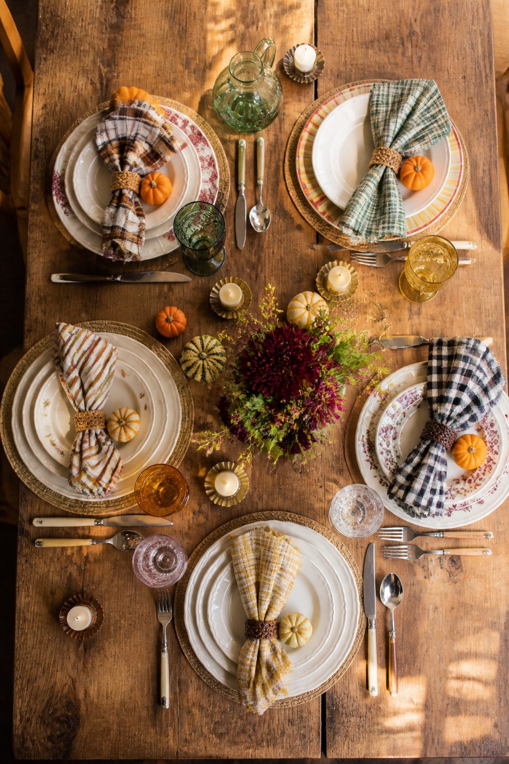 Assorted tableware in a cohesive color palette for a fall setting.
