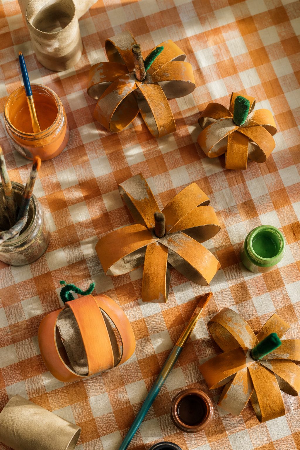 25 Pumpkin Craft Ideas for Fall Decor, Kids, and Adults (2026) 7 Craft pumpkins made from cut and curled toilet paper rolls.