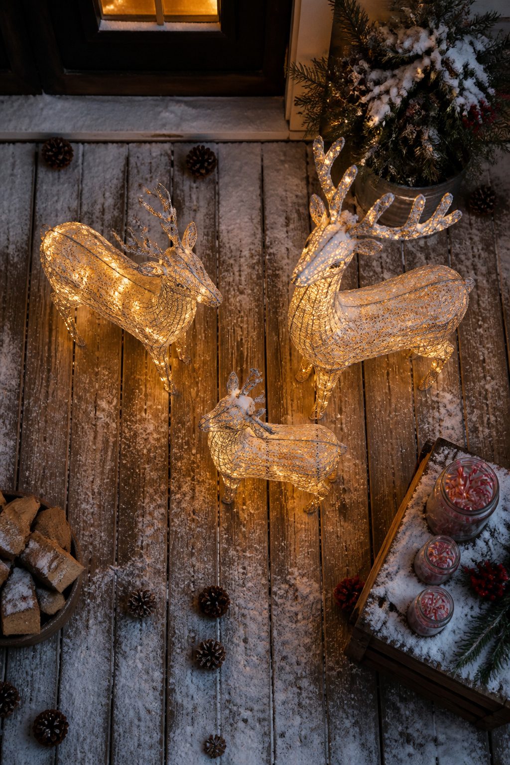 Rustic porch decor with a large reindeer and smaller accent pieces.