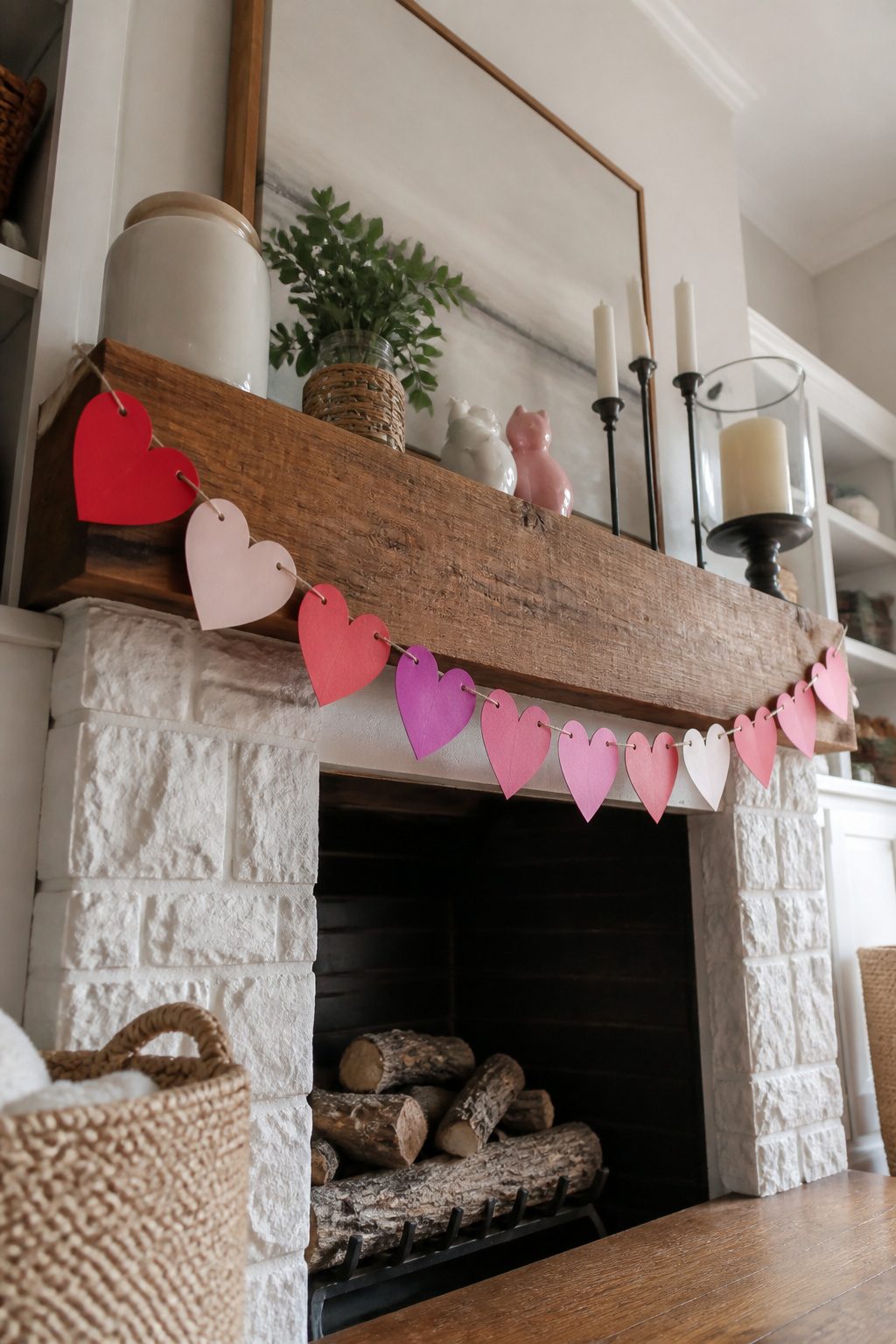 Handmade banner strung across a mantel with paper hearts.