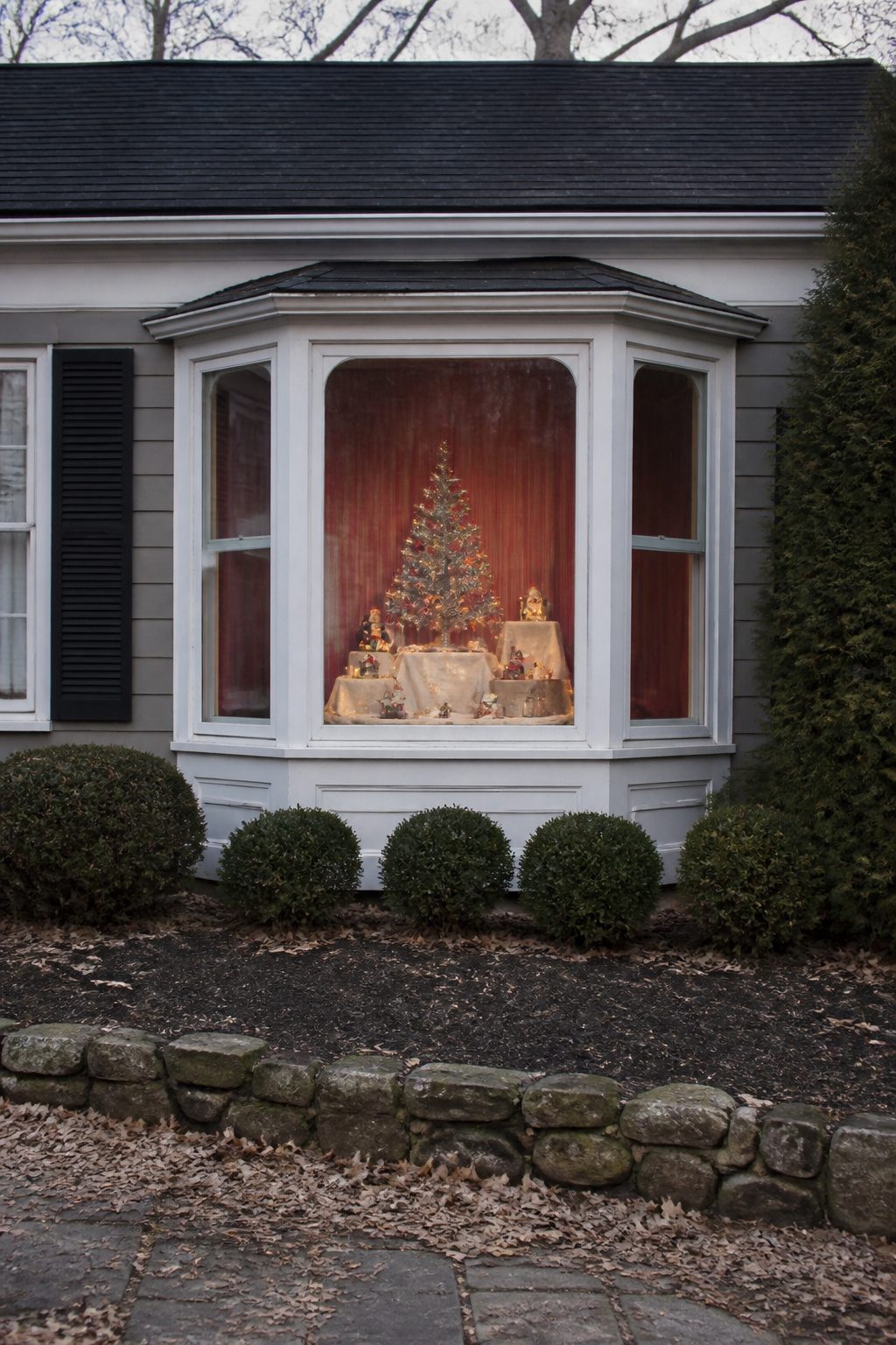 Vintage Christmas Display: Ornaments, Trees, Cards & Ephemera 25 A decorative window display with layered holiday objects.