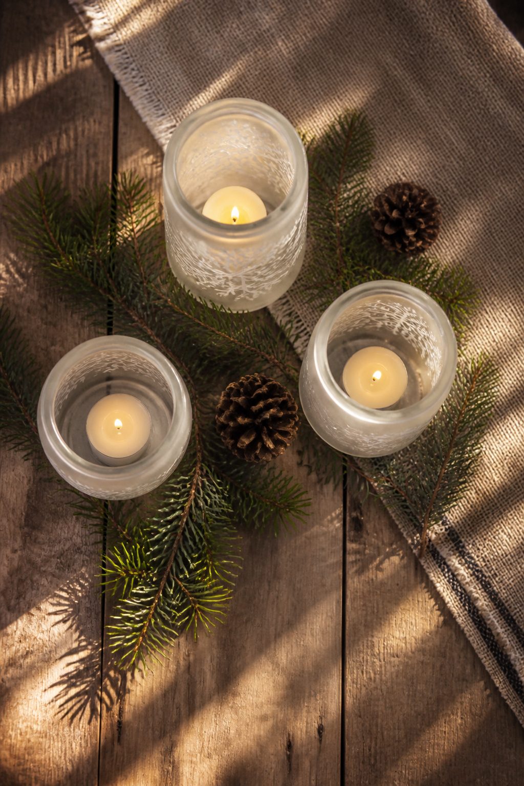 10 Winter Crafts for Adults to Make in 2026 9 Glass jars used as candle holders with various designs.